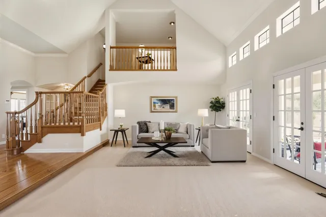 a living room with furniture a fireplace and a window