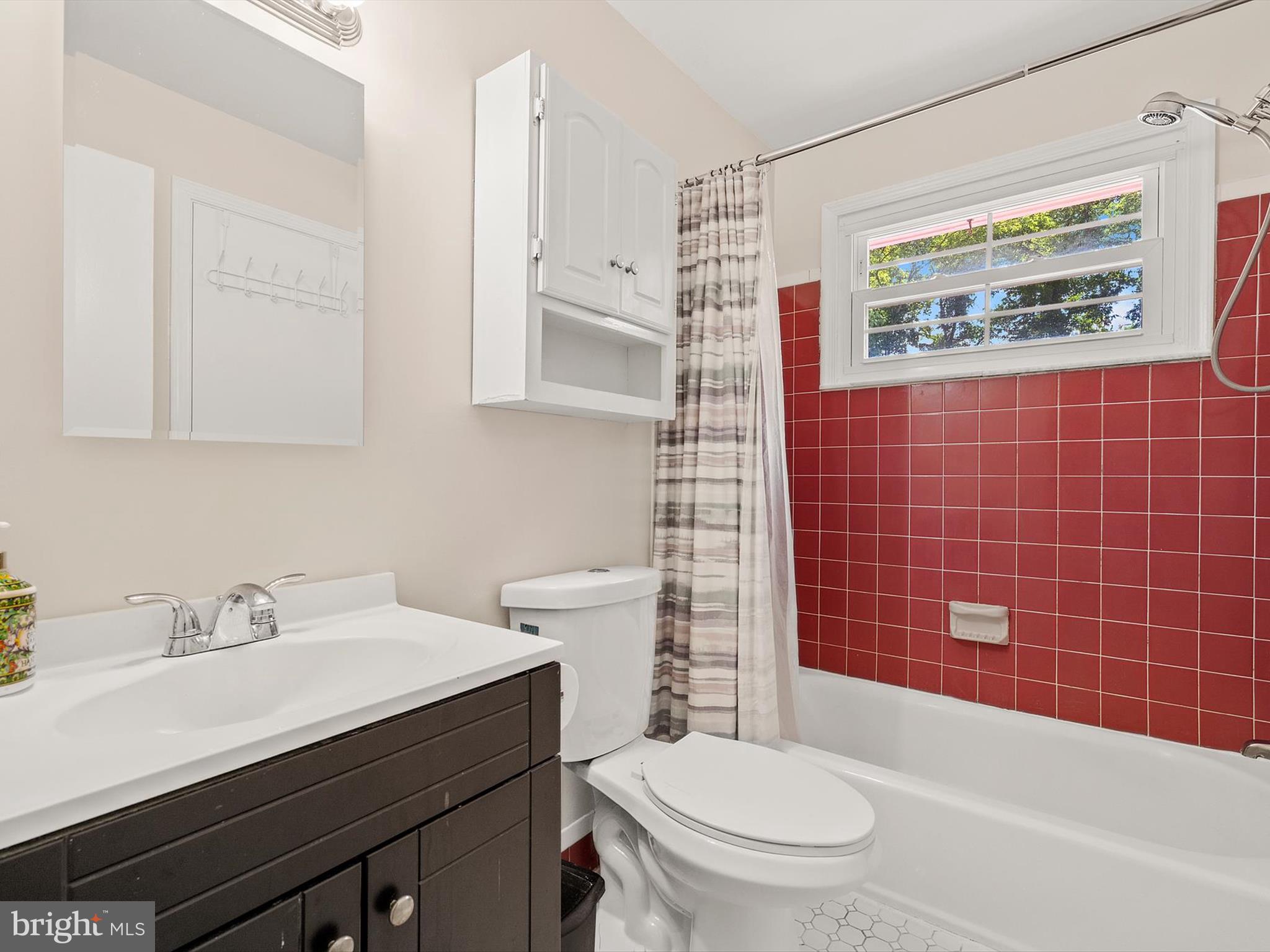 10525 Edgemont Drive Adelphi, MD 20783 - Photo 19 of 36 a bathroom with a sink a toilet and shower