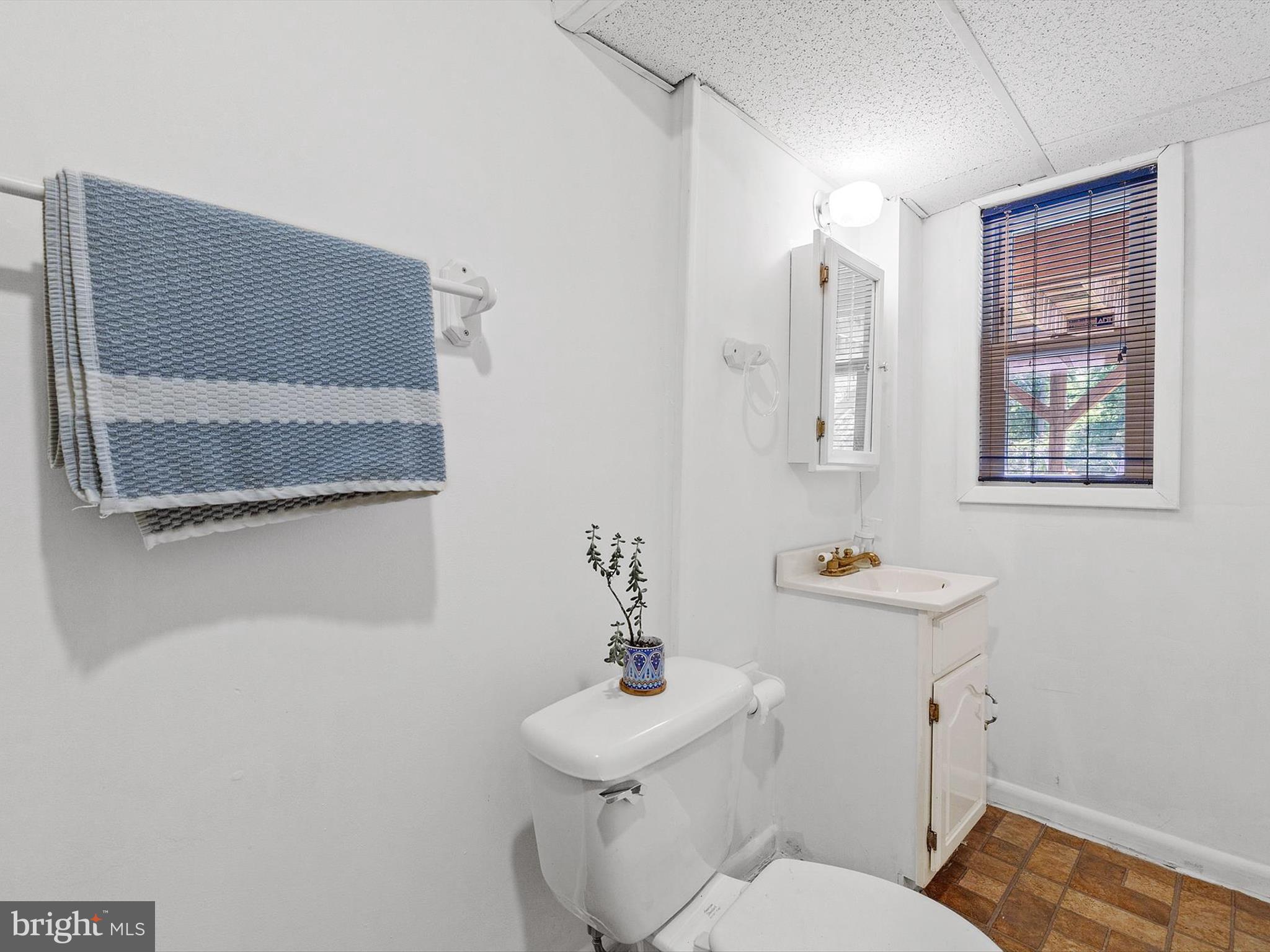10525 Edgemont Drive Adelphi, MD 20783 - Photo 23 of 36 a bathroom with a toilet a sink and mirror