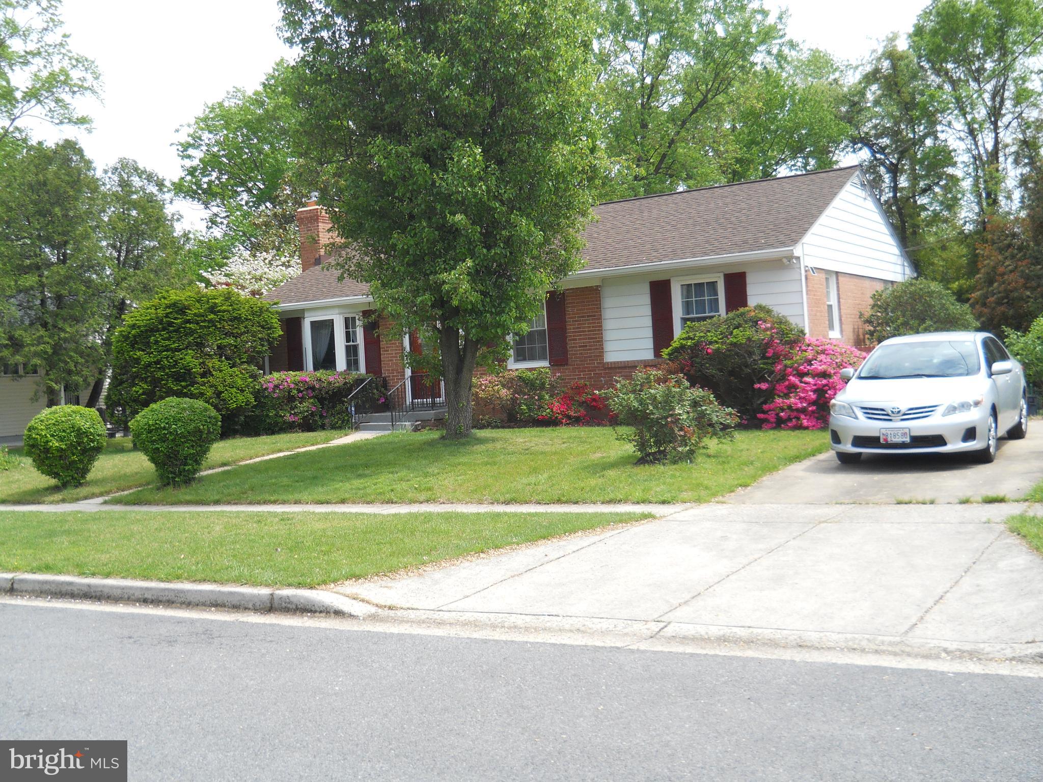 10525 Edgemont Drive Adelphi, MD 20783 - Photo 3 of 36 a front view of a house with a yard and garage