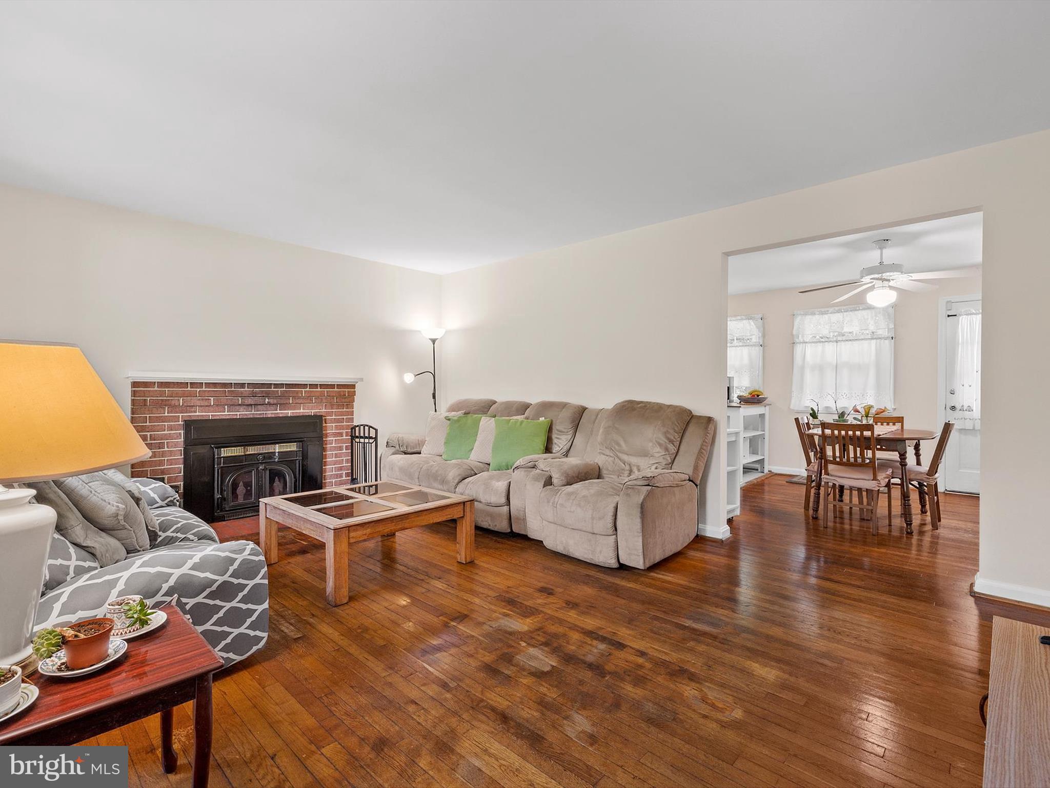 10525 Edgemont Drive Adelphi, MD 20783 - Photo 4 of 36 a living room with furniture a fireplace and a table