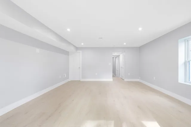 an empty room with windows and closet