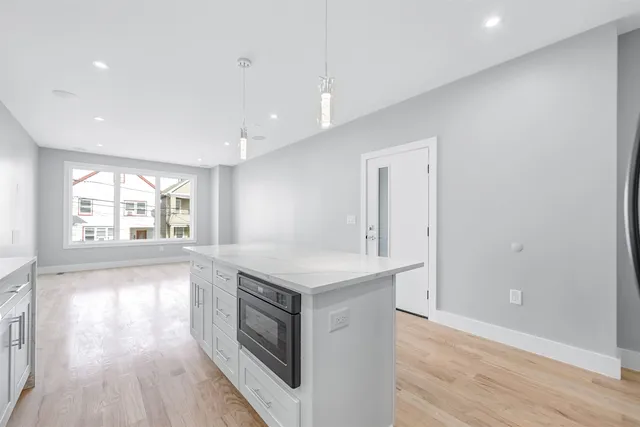 a kitchen with a stove a sink and a refrigerator
