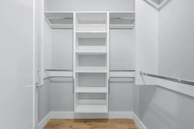 a view of walk in closet with empty racks