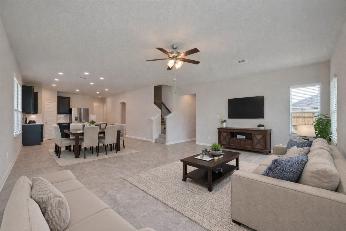 1015 Modesto Drive Rosharon, TX 77583 - Photo 11 of 37 Wide open living area with direct sightlines into the kitchen, making entertaining effortless! The neutral color palette and abundant natural light create a bright and airy feel throughout. *Virtually Staged* Vacant and ready for your memories!