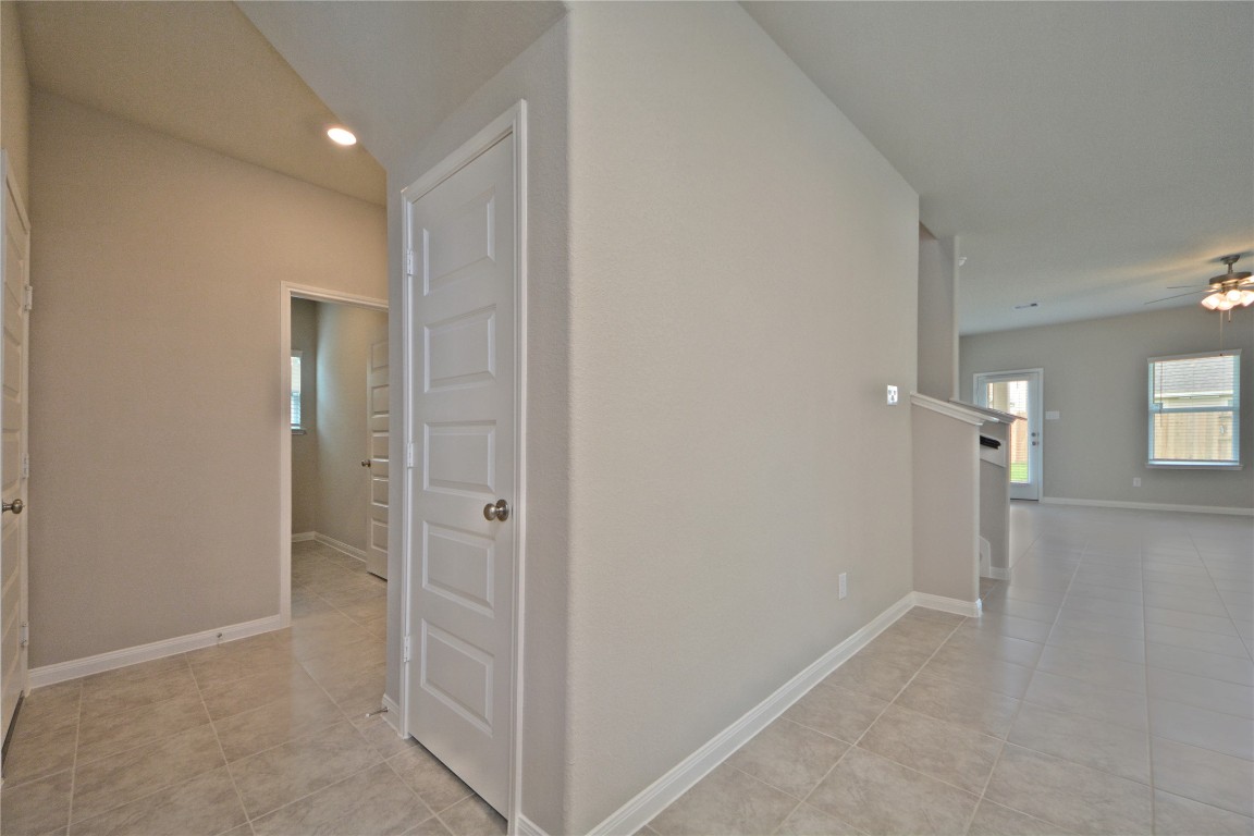 1015 Modesto Drive Rosharon, TX 77583 - Photo 22 of 37 Bright and open hallway connecting the living areas with a seamless flow throughout the home! Clean lines and neutral tones provide a warm and inviting feel from room to room. Notice no carpet but in the primary bedroom downstairs!