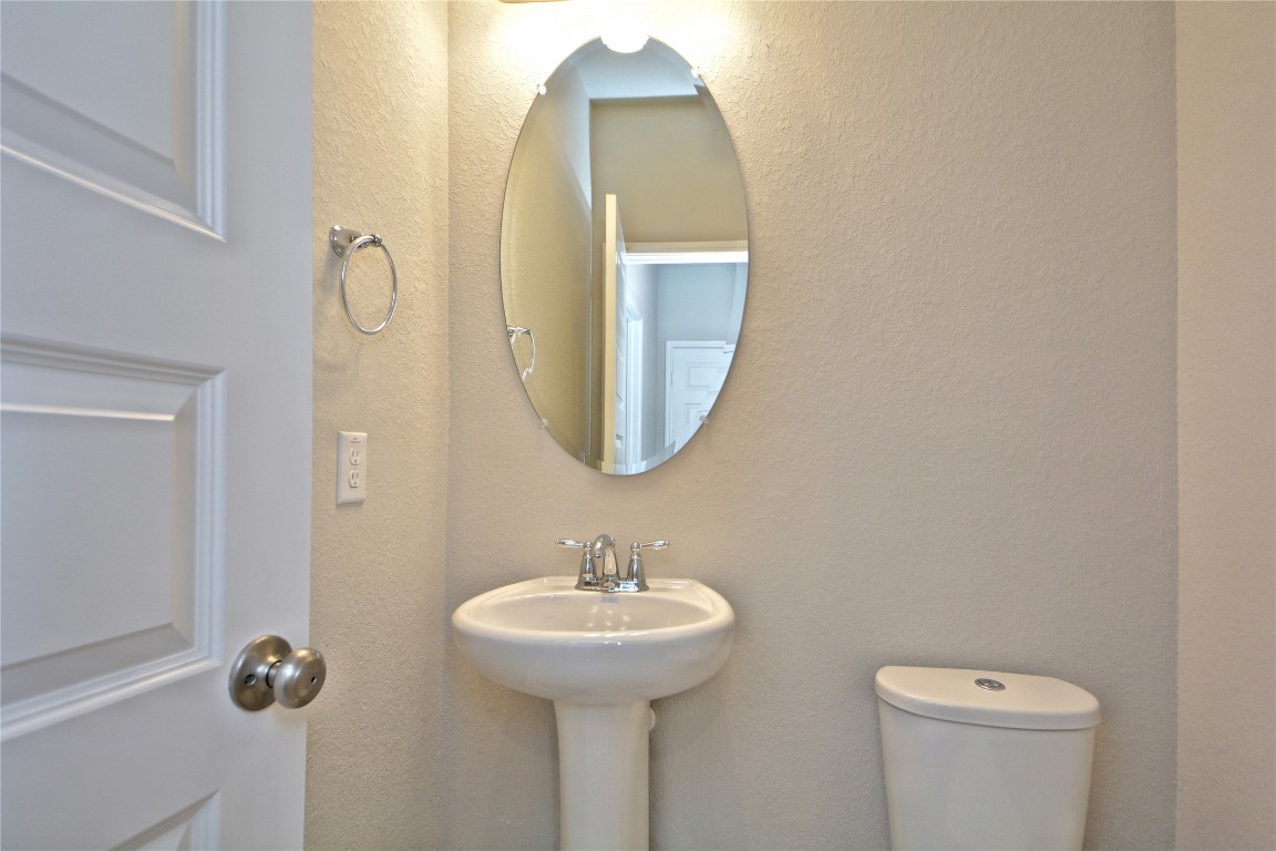 1015 Modesto Drive Rosharon, TX 77583 - Photo 23 of 37 Convenient guest powder room featuring a pedestal sink and clean finishes, perfect for visitors! A great added feature for functionality and comfort. Make this home yours today!