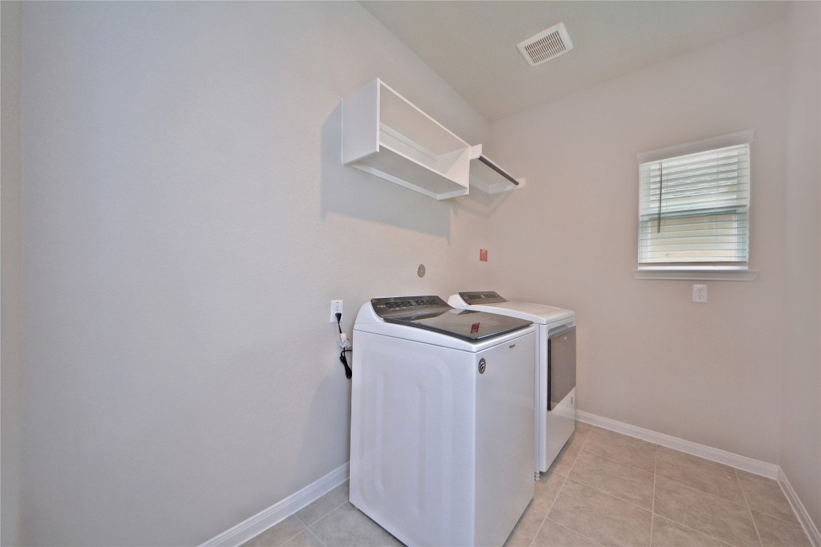 1015 Modesto Drive Rosharon, TX 77583 - Photo 24 of 37 Convenient utility room complete with washer and dryer included, plus built in shelving for extra storage! A functional and practical space designed to make everyday chores easy and efficient.