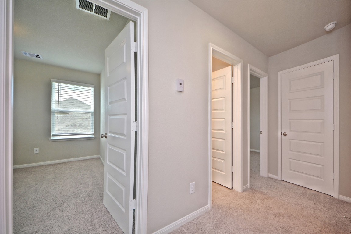 1015 Modesto Drive Rosharon, TX 77583 - Photo 27 of 37 Well designed upstairs hallway leading to multiple bedrooms and bath areas, offering privacy and convenience for family or guests! Thoughtful layout makes this home both functional and inviting. CALL NOW and make this home yours!