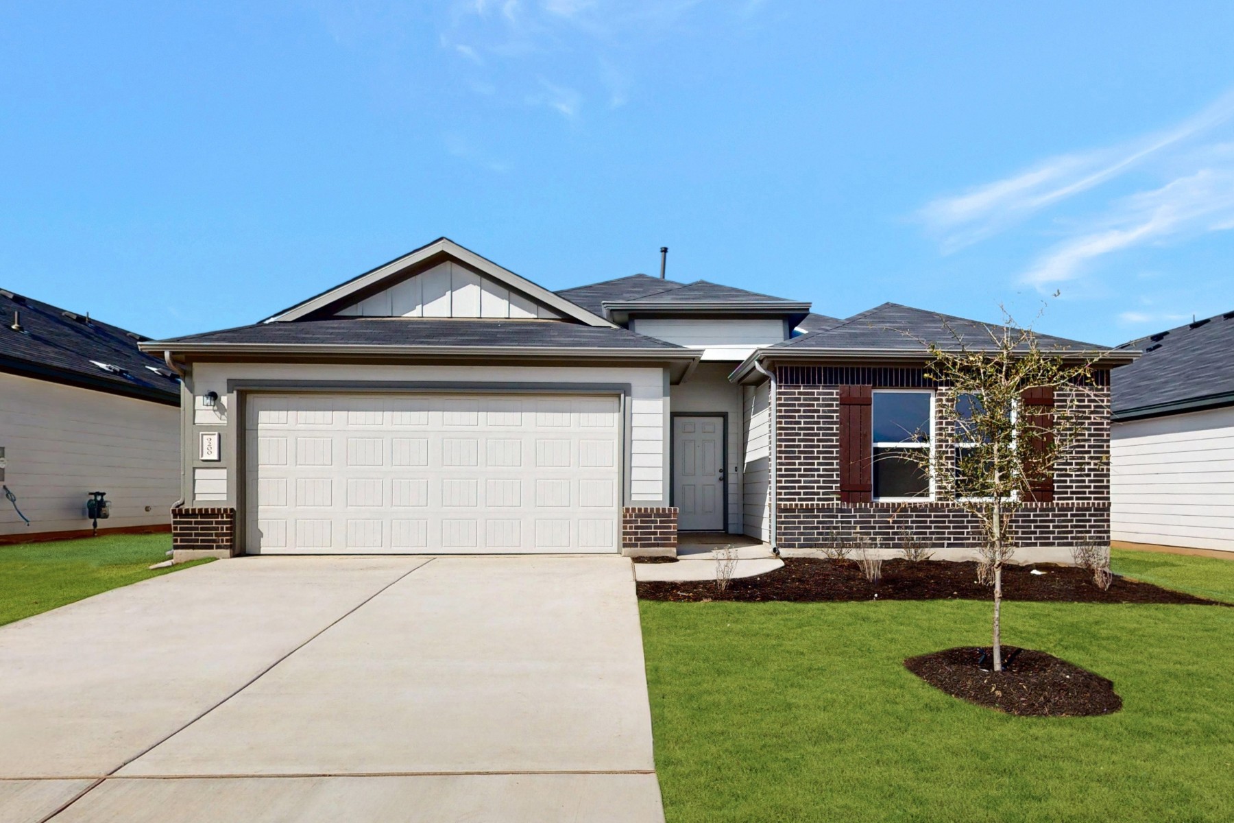 9200 Corvallis Drive Austin, TX 78747 - Photo 1 of 33 a front view of a house with a garden