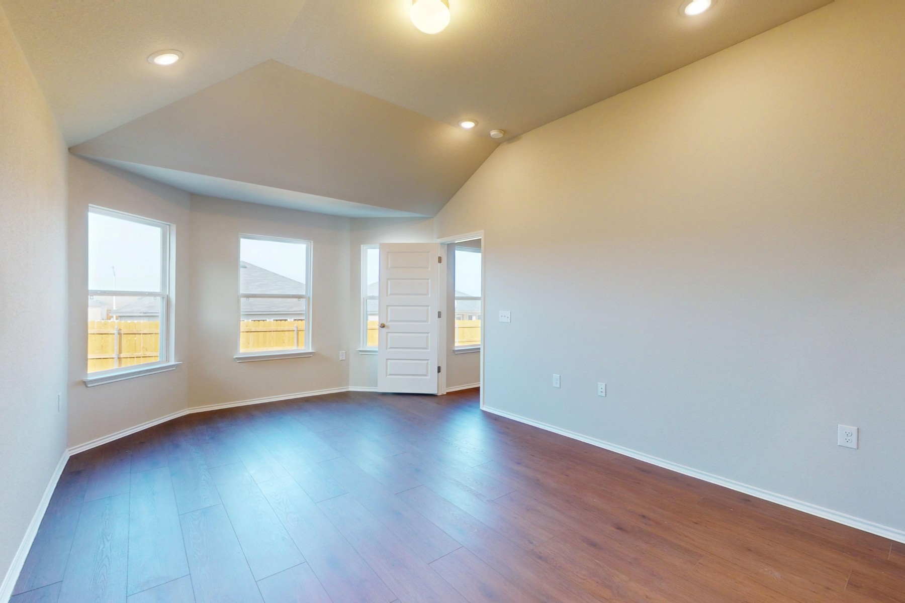 9200 Corvallis Drive Austin, TX 78747 - Photo 11 of 33 an empty room with wooden floor and windows