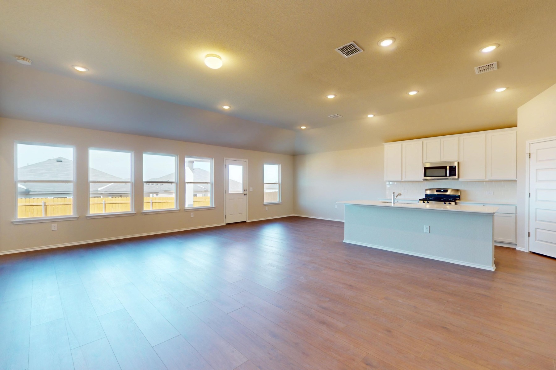 9200 Corvallis Drive Austin, TX 78747 - Photo 2 of 33 a view of kitchen with stainless steel appliances granite countertop a large counter top a wooden floors and a large window