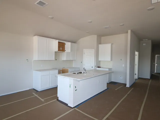 a kitchen with a sink cabinets and window