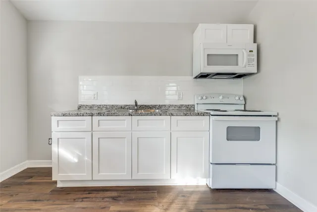 a view of a kitchen with electric appliances