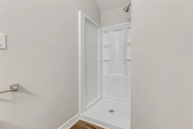a bathroom with a granite countertop toilet sink and mirror