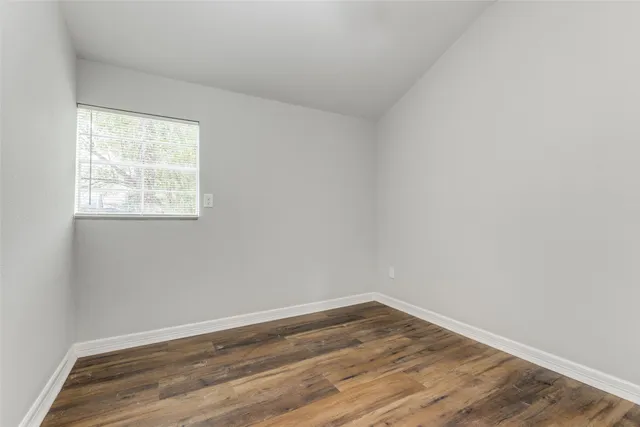 an empty room with wooden floor