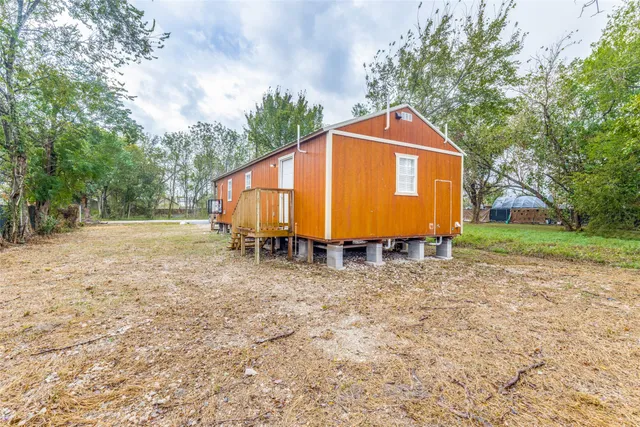 a backyard of a house with barbeque oven