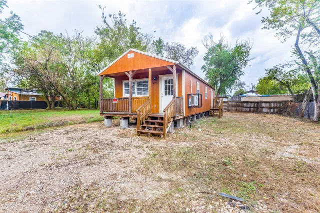 a view of a house with a wooden fence