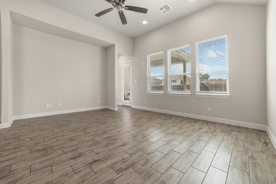 2229 Base Burner Path Leander, TX 78641 - Photo 12 of 40 a view of an empty room with a window and wooden floor