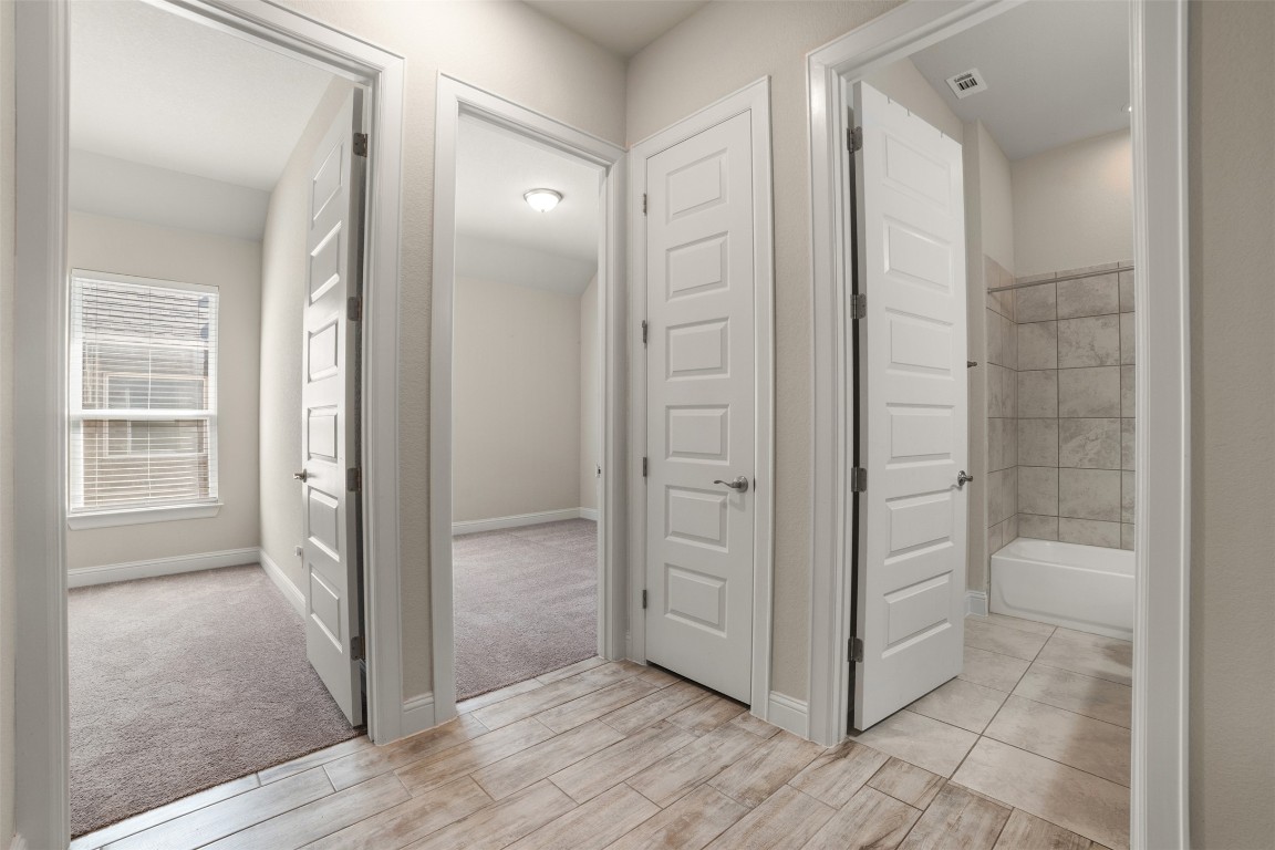 2229 Base Burner Path Leander, TX 78641 - Photo 14 of 40 an empty room with wooden floor and mirror