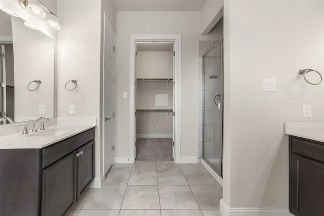 a spacious bathroom with a granite countertop sink and a mirror
