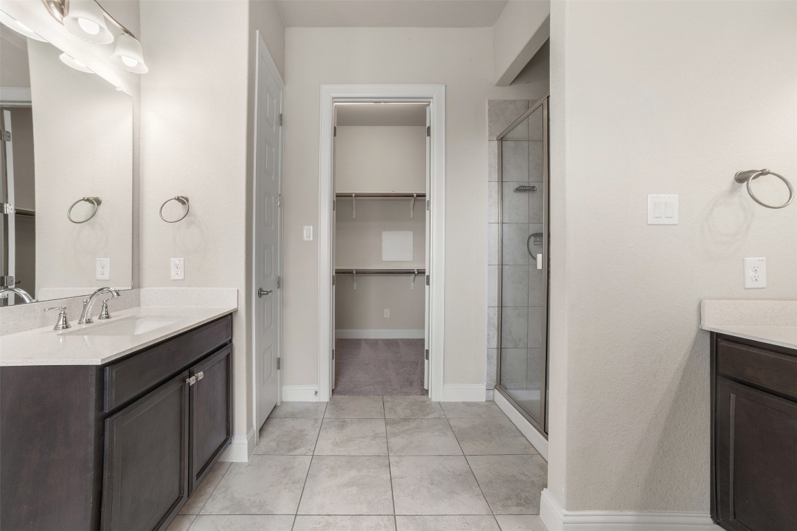 2229 Base Burner Path Leander, TX 78641 - Photo 23 of 40 a spacious bathroom with a granite countertop sink and a mirror
