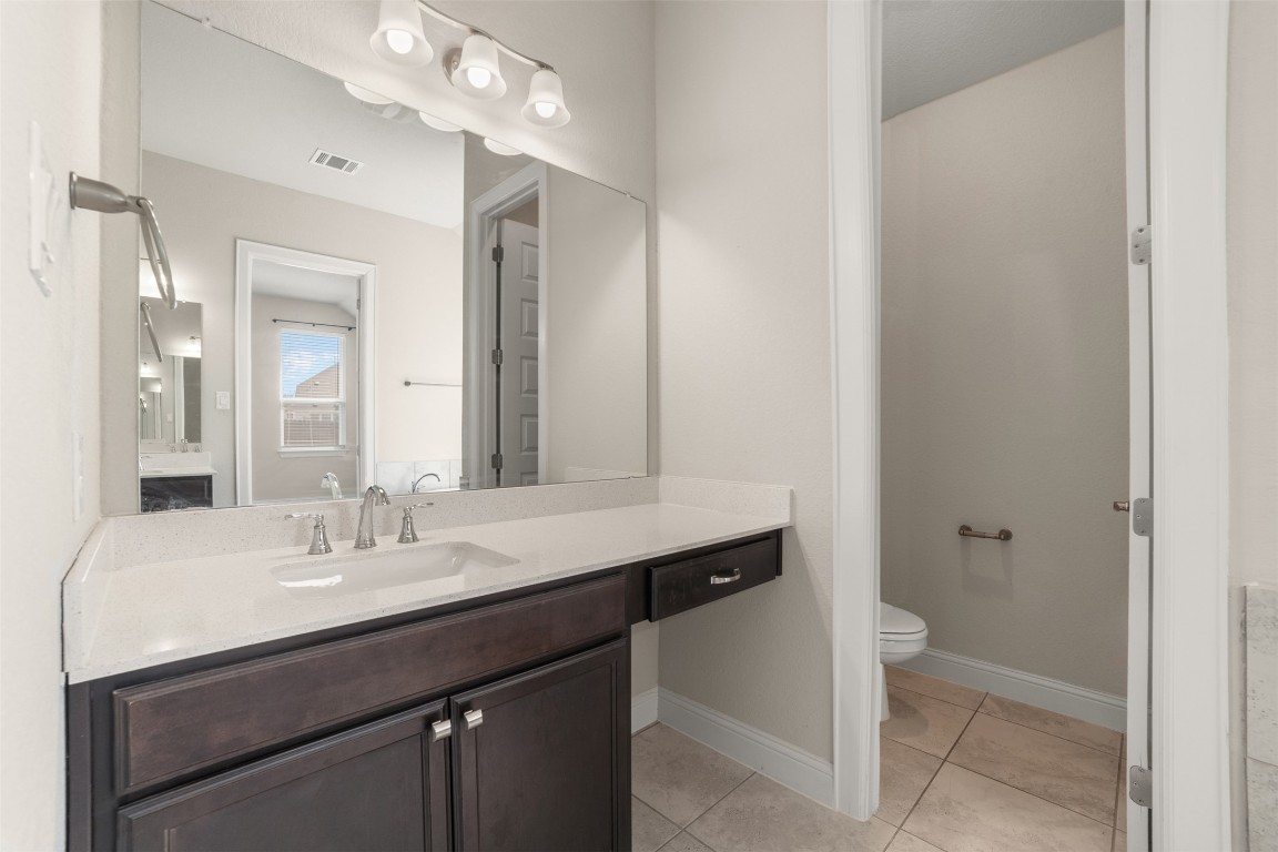 2229 Base Burner Path Leander, TX 78641 - Photo 28 of 40 a bathroom with a sink a toilet and a mirror