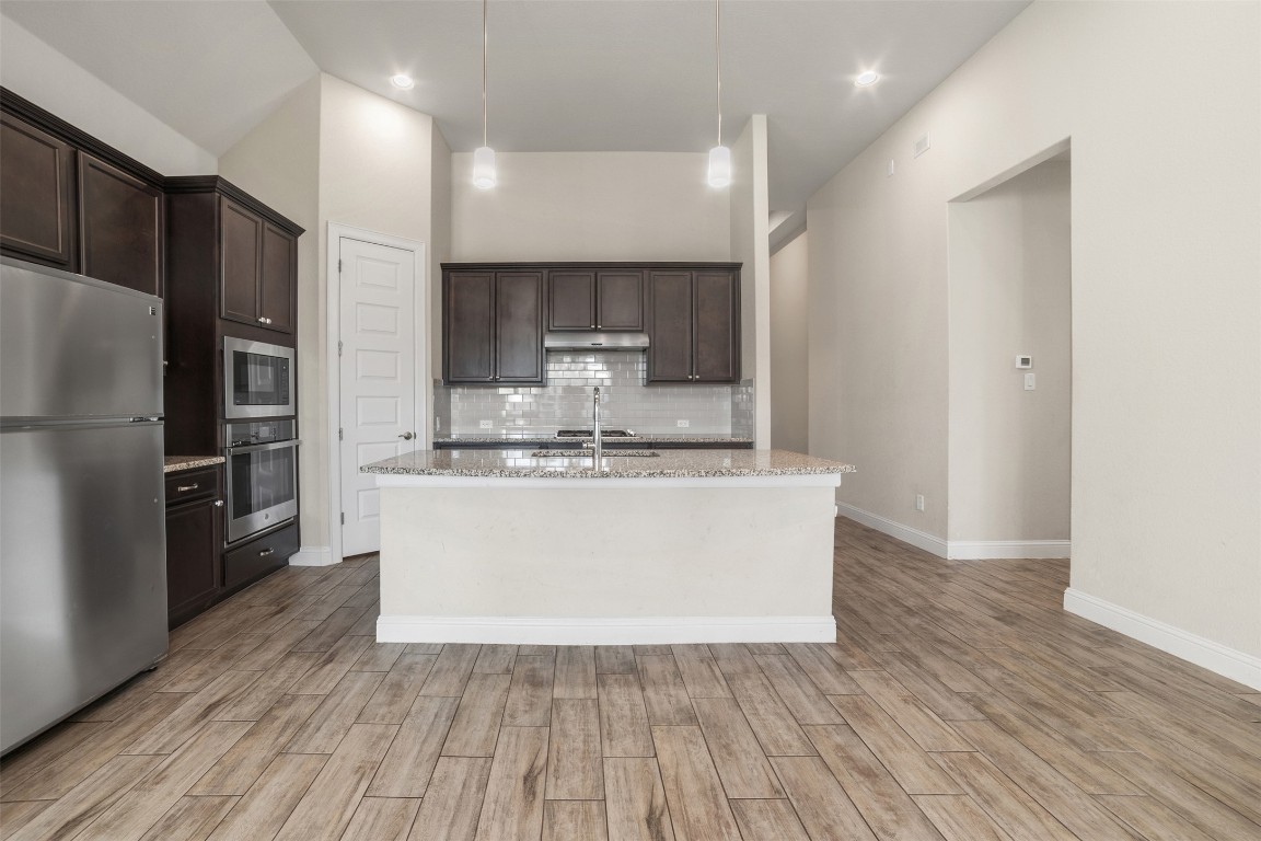 2229 Base Burner Path Leander, TX 78641 - Photo 7 of 40 a view of kitchen with stainless steel appliances wooden floor
