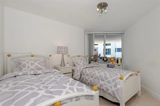 a bedroom with two beds and painted walls