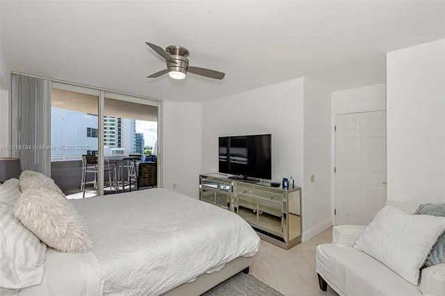 a bedroom with bed and flat screen tv