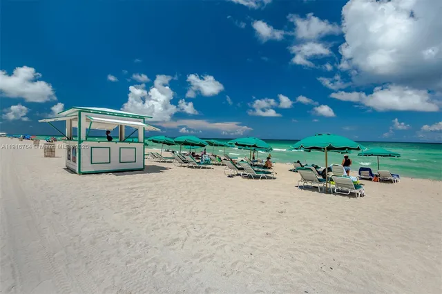 a view of a patio with a table and chairs and potted plants