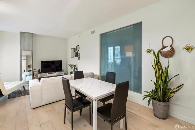 a living room with furniture potted plant and a flat screen tv