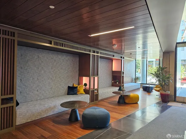 a living room with patio furniture and a large window