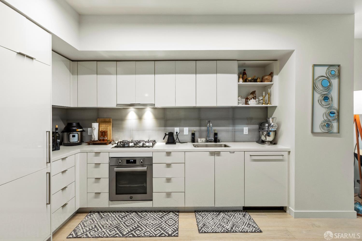Arkansas Street San Francisco, CA 94107 - Photo 2 of 32 a kitchen with granite countertop white cabinets and white appliances
