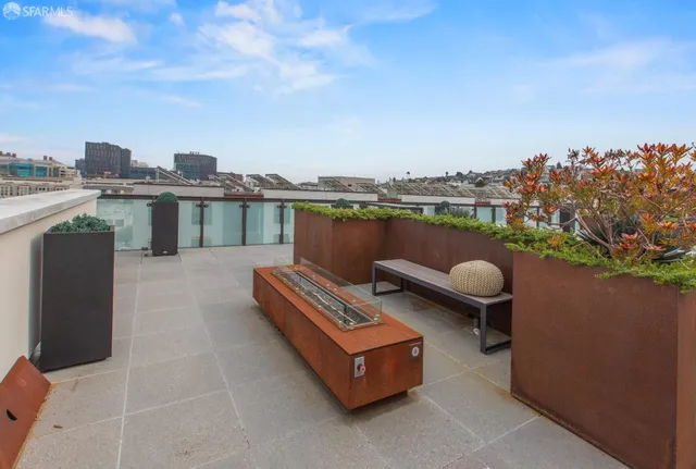 a view of roof deck with two chairs and a table
