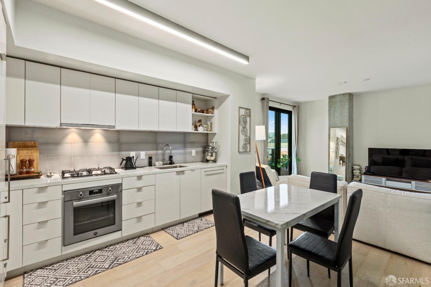 Arkansas Street San Francisco, CA 94107 - Photo 4 of 32 a kitchen with a stove a sink dishwasher a dining table and chairs with wooden floor