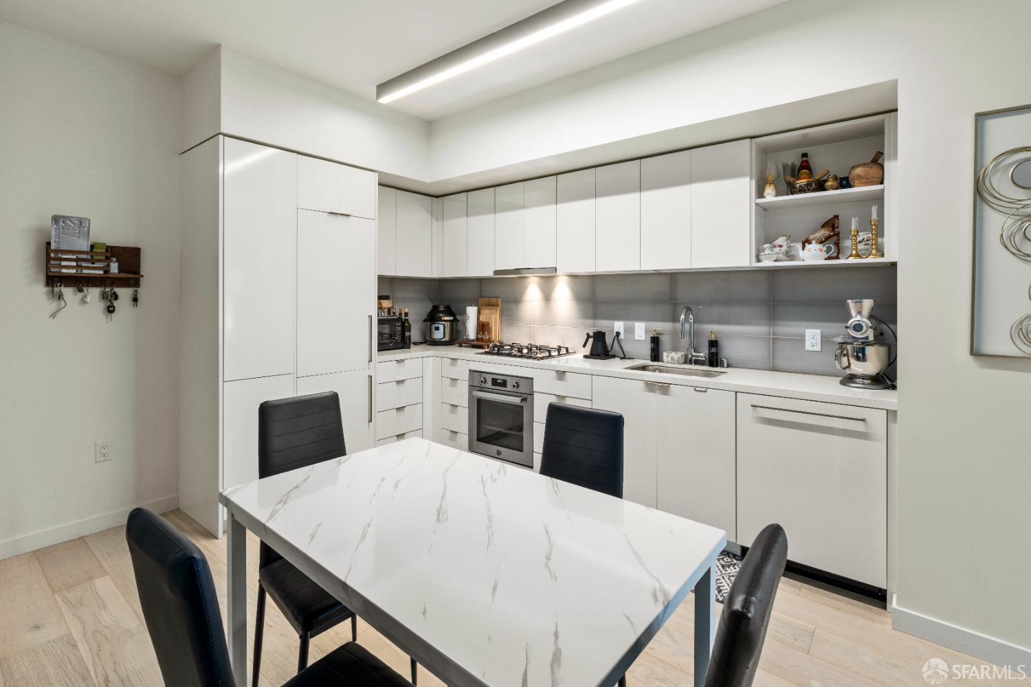 Arkansas Street San Francisco, CA 94107 - Photo 5 of 32 a kitchen with a table chairs refrigerator and cabinets