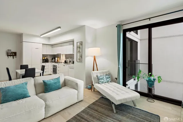 a living room with furniture and a potted plant