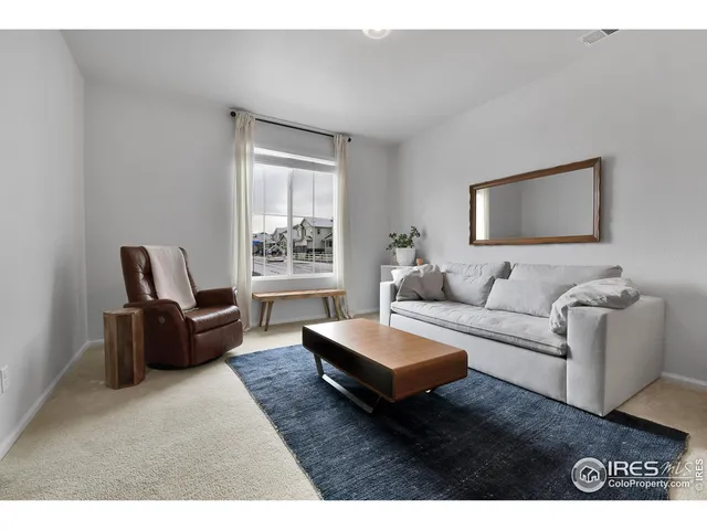 a living room with furniture gym equipment and a flat screen tv