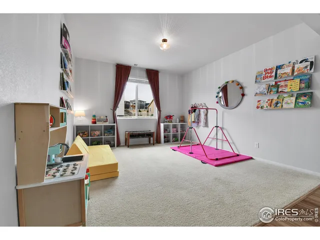 a kitchen with stainless steel appliances granite countertop a stove a kitchen island a dining table and chairs with wooden floor