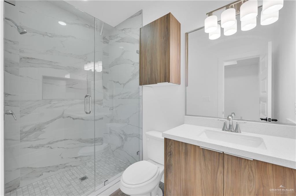 2903 Gabriel Street, Unit 4 Mission, TX 78574 - Photo 11 of 12 a bathroom with a sink a toilet and shower