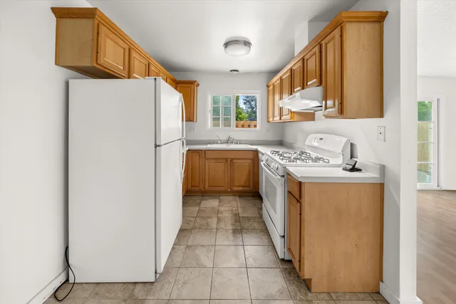 a kitchen with a refrigerator a washer and dryer