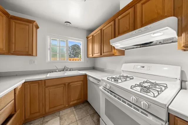 a kitchen with a stove and a sink