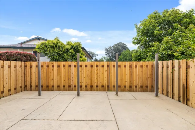 a view of a building with wooden fence