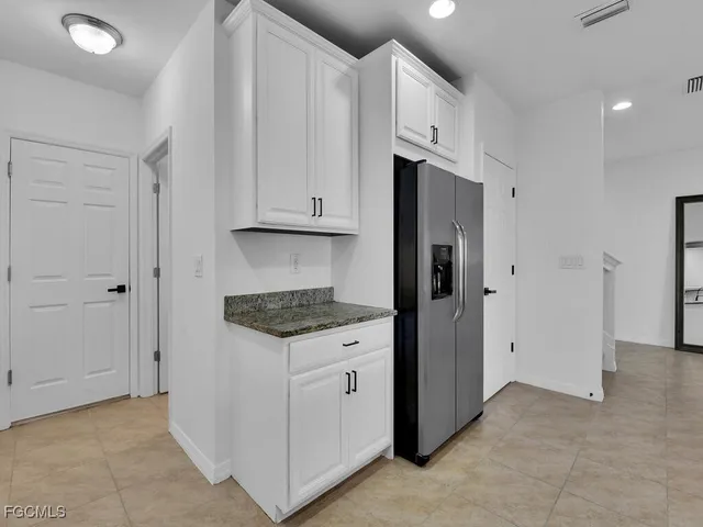 a kitchen with stainless steel appliances granite countertop a refrigerator and a stove