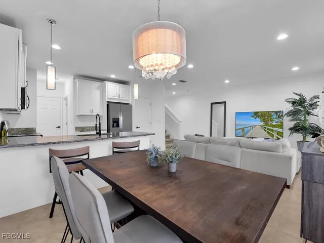 a large kitchen with a table and chairs in it