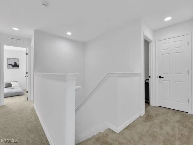 a view of a hallway with closet and cabinet