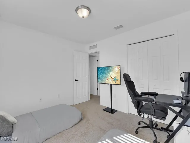 a view of a workspace with furniture and a window