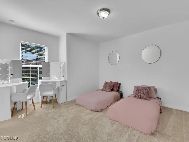 a bedroom with furniture and a large window