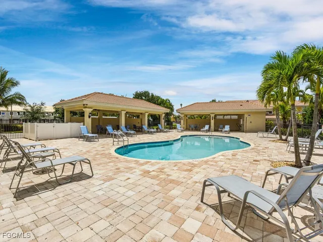 a view of a swimming pool with lawn chairs